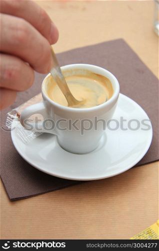 Man stiring an espresso