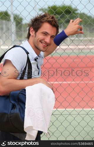 Man stood by tennis court