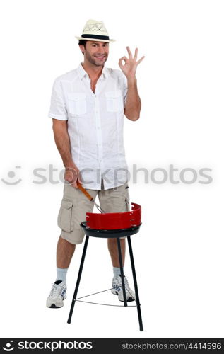 Man stood cooking on barbecue