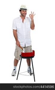Man stood cooking on barbecue