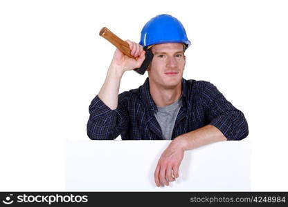 Man stood with mallet and blank poster