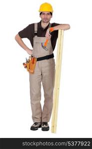 Man stood with plank of wood and hammer