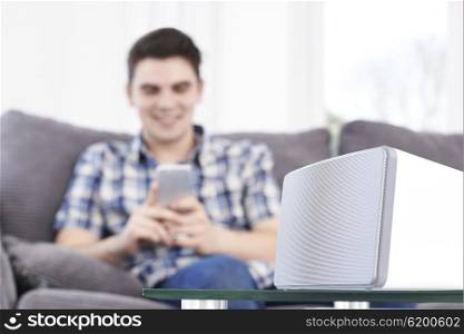 Man Streams Music From Mobile Phone To Wireless Speaker
