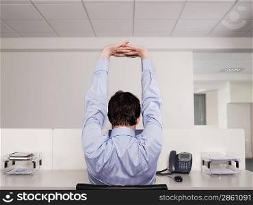 Man Stretching at Desk