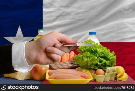 man stretching out credit card to buy food in front of complete wavy american state flag of texas