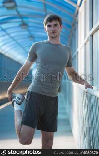 Man stretching outdoors in city