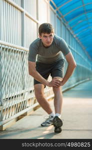 Man stretching outdoors in city