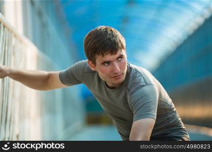 Man stretching outdoors in city before jogging