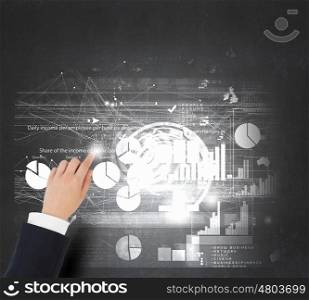 Man striking balance. Businessman analyzing financial statistics displayed on tablet screen