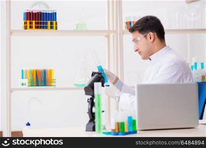 Man student working in chemical lab on experiment