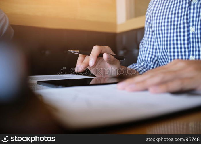 Man student writes information from portable tablet while prepare for lectures in University campus.