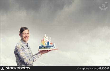 Man study engineering. Young man in casual holding opened book with construction concept