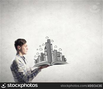 Man study engineering. Young man in casual holding opened book with construction concept