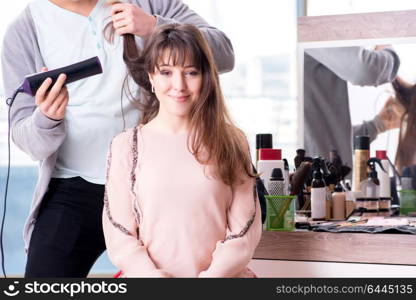 Man stylist working with woman in beauty salon