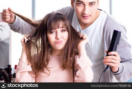 Man stylist working with woman in beauty salon. The man stylist working with woman in beauty salon