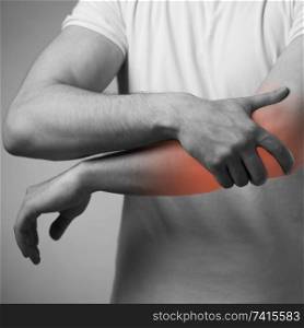 Man suffering from acute pain in elbow