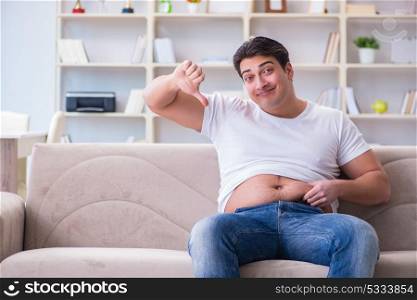 Man suffering from extra weight in diet concept
