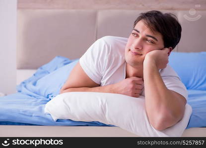 Man suffering from insomnia lying in bed