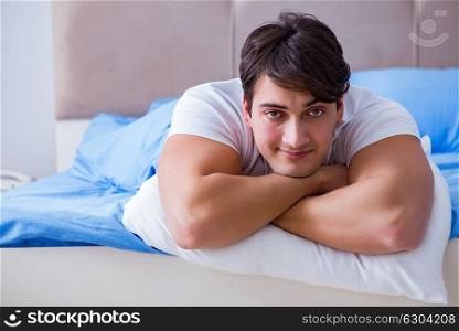 Man suffering from insomnia lying in bed