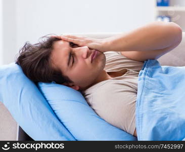 Man suffering from insonmia in bed at home