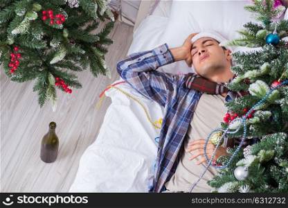 Man suffering hangover after christmas party. The man suffering hangover after christmas party
