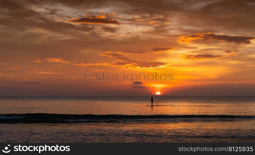 man surfing in the summer sunset