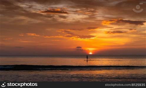 man surfing in the summer sunset