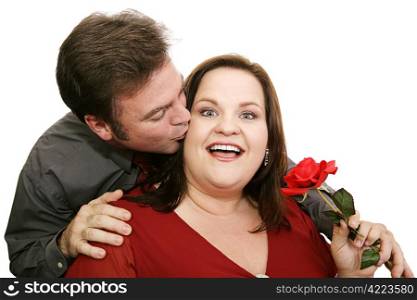 Man surprises his date by giving her a rose and a kiss. Isolated on white.