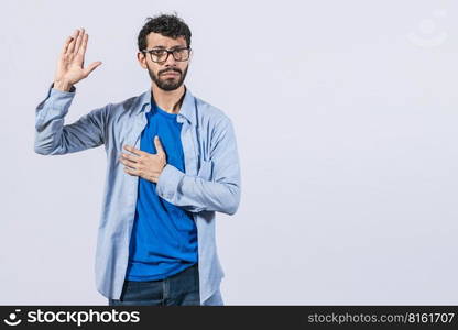 Man swearing honesty and devotion, Honest man raising his hand, a A guy raising his hand swearing, young man raising a hand promising something