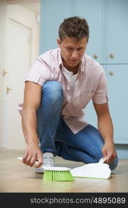 Man Sweeping Floor With Dustpan And Brush