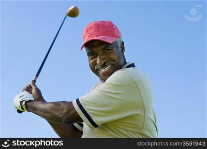 Man Swinging Golf Club