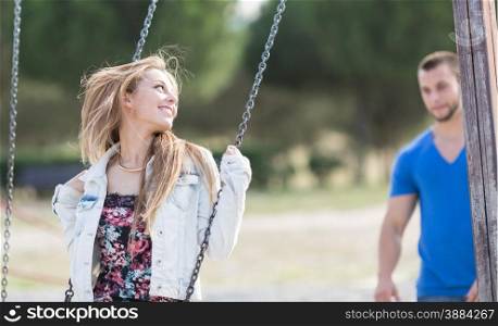 Man swinging his girl in a park