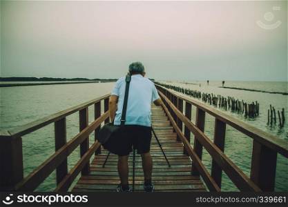 Man take photo on long bridge at sea view