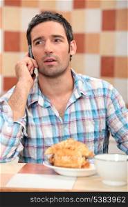 Man taking a call at breakfast