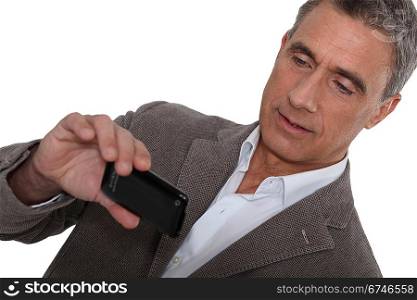 Man taking a picture using his mobile phone