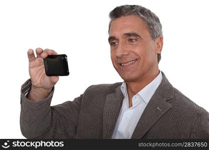 Man taking a self-portrait with his cameraphone