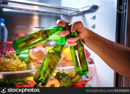 Man taking beer from a fridge