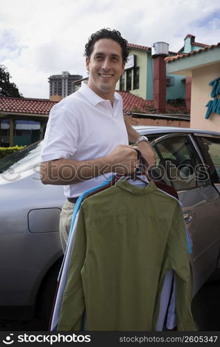 Man taking clothes out of car