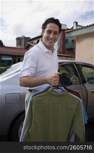 Man taking clothes out of car
