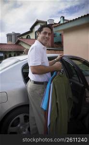 Man taking clothes out of car