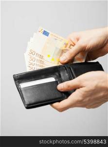 man taking euro cash money out of the wallet