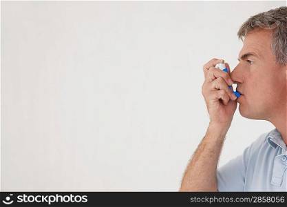 Man Taking Inhaler