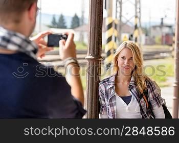 Man taking photograph of woman digital camera vacation smiling couple