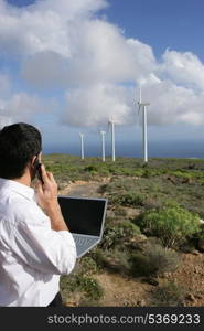 Man taking reading from wind farm