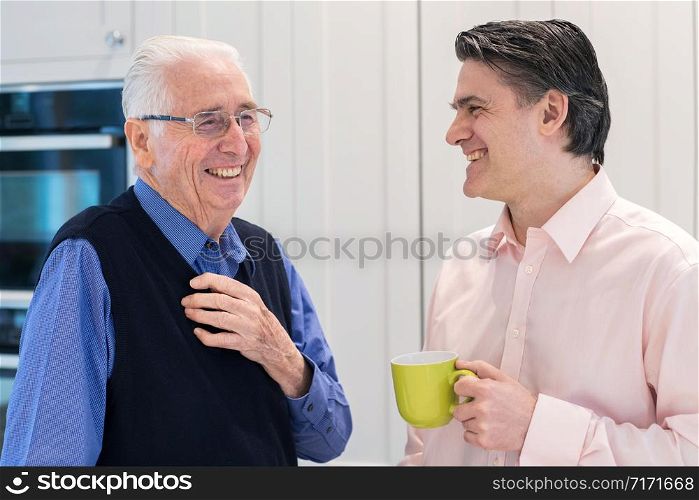Man Taking Time To Visit Senior Male Neighbor And Talk
