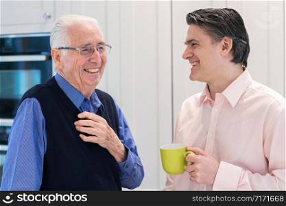 Man Taking Time To Visit Senior Male Neighbor And Talk