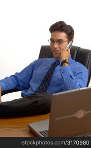 Man Talking on Cell Phone at Desk