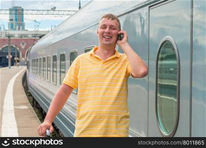 man talking on the phone in train station