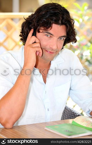 Man talking over the phone in his garden.