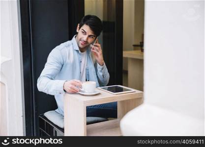 man talking smartphone sitting cafe